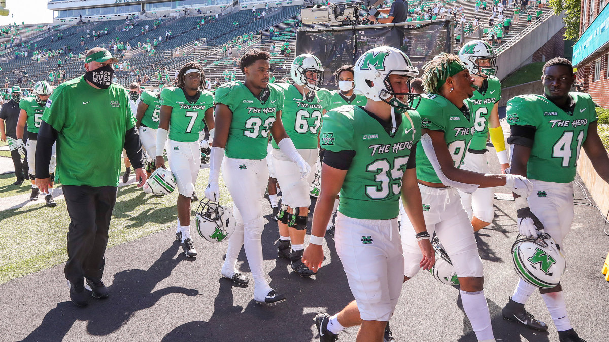 Marshall football players walk to the tunnel